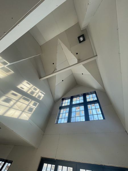 Hung board on a vaulted ceiling over a gable window