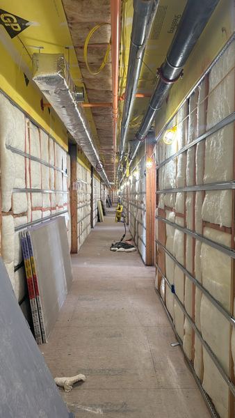 Corridor with metal channel and board staged